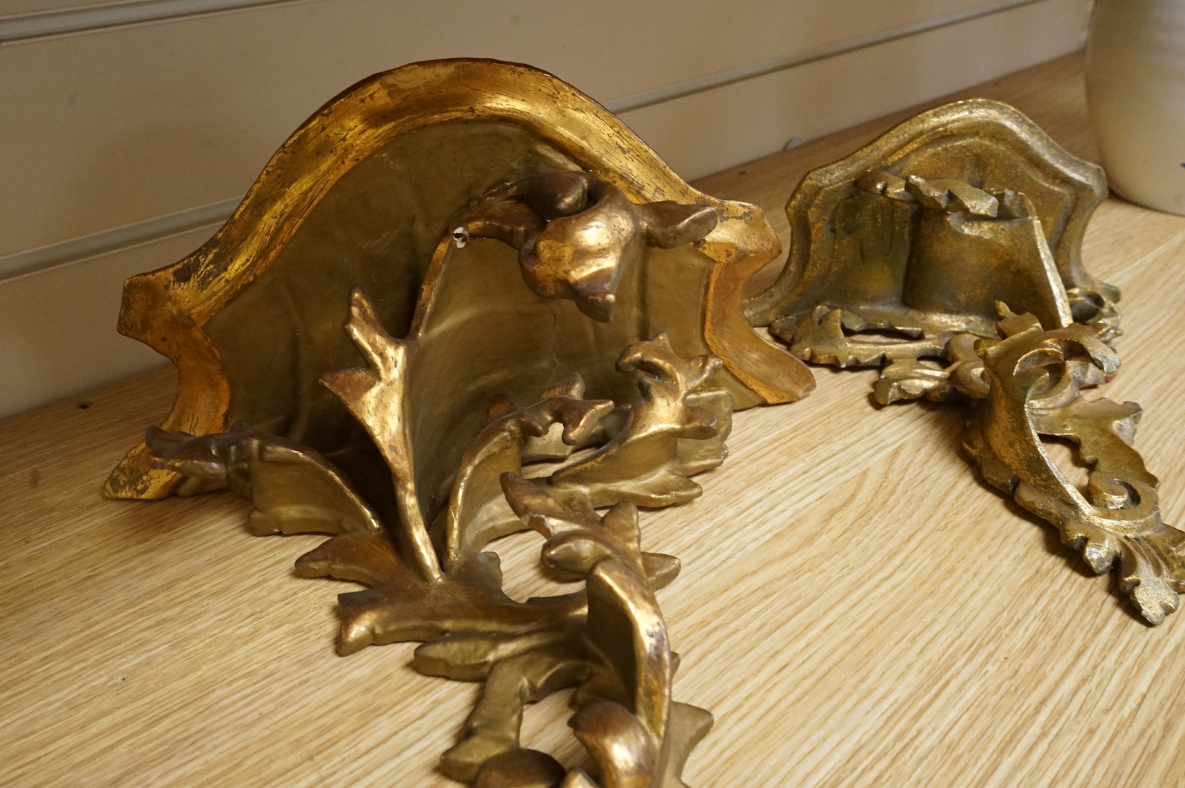A large giltwood wall bracket- 28cm high together with a smaller similar wall bracket.